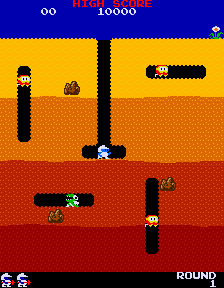 Dig Dug mid-round: tunnels carved through four bands of coloured earth, Dig Dug in his shaft with three Pookas and a Fygar loose and two rocks poised above