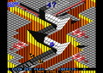 Marble Madness practice race: the marble part-way down an isometric course of grey chequered ramps and red rails over orange and yellow ground, with SCORE and the countdown timer above and the coin line below