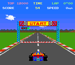 Pole Position on the starting grid: the red and blue Formula 1 car at the bottom of a grey track lined with red and white kerbs, under a yellow START gantry with chequered flags, green grass and a blue sky either side, TOP SCORE, TIME, LAP and SPEED across the top